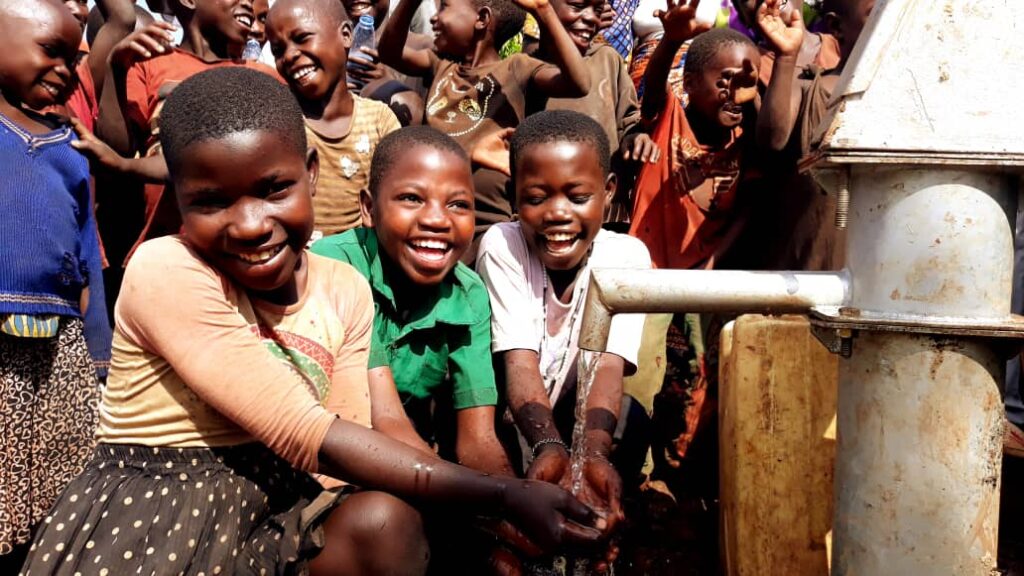 Children Smiling at a Well, Donate a Well Today